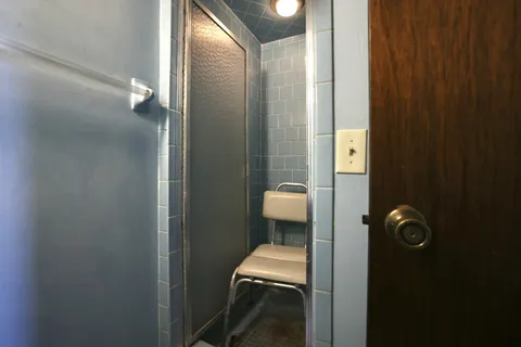 an empty room with windows and closet area