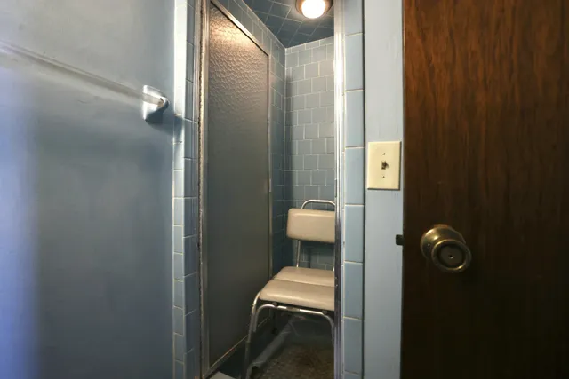 an empty room with windows and closet area