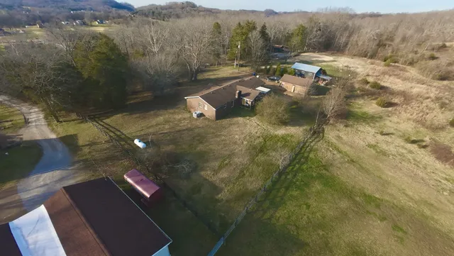 a view of a yard with wooden fence