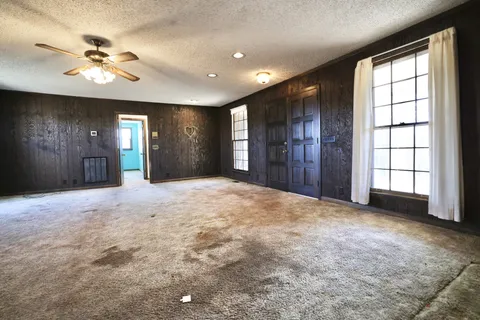 a view of an empty room with a fireplace
