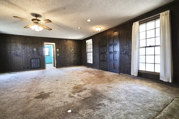 a view of an empty room with a fireplace