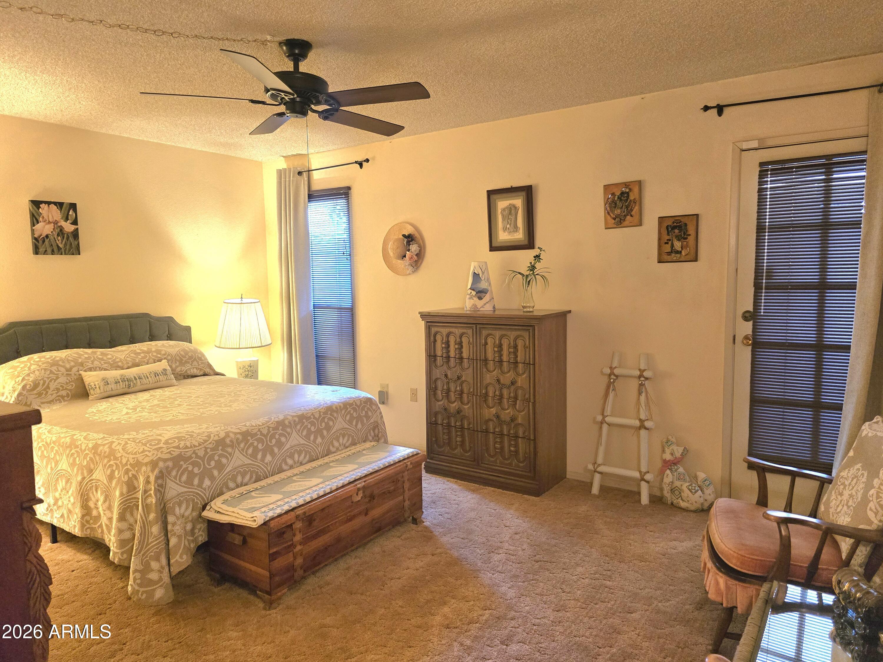 11634 North Rio Vista Drive Sun City, AZ 85351 - Photo 4 of 15 a spacious bedroom with a bed and a chandelier