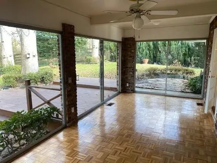 a view of empty room with wooden floor