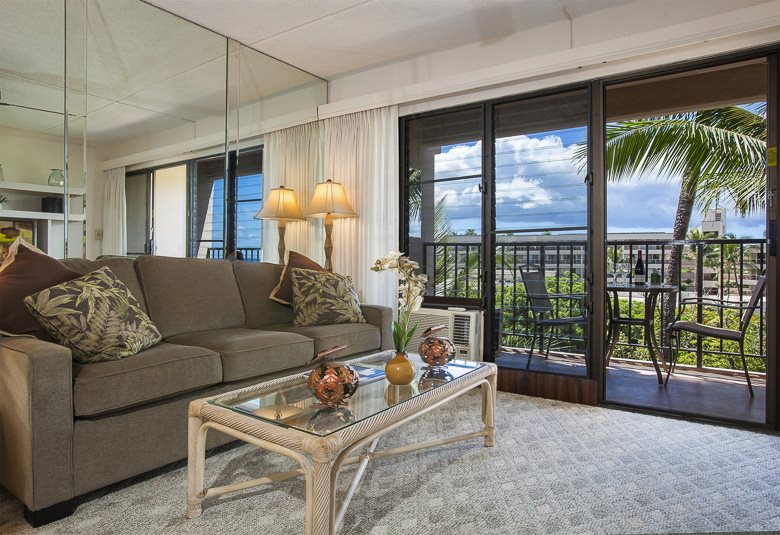 2531 South Kihei Road, Unit C512 Kihei, HI 96753 - Photo 11 of 27 a living room with furniture and a large window with palm tree