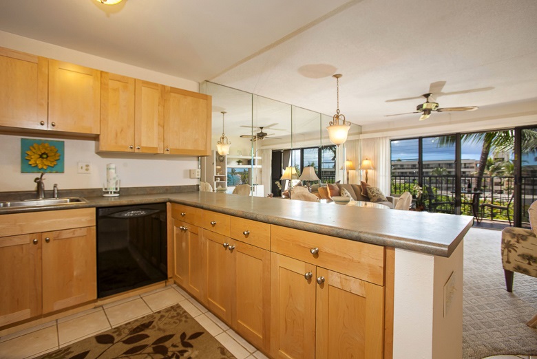 2531 South Kihei Road, Unit C512 Kihei, HI 96753 - Photo 6 of 27 a kitchen with kitchen island granite countertop a sink and white cabinets