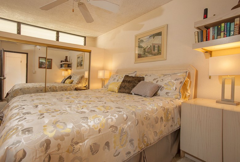 2531 South Kihei Road, Unit C512 Kihei, HI 96753 - Photo 8 of 27 a bedroom with a bed a mirror and lamp