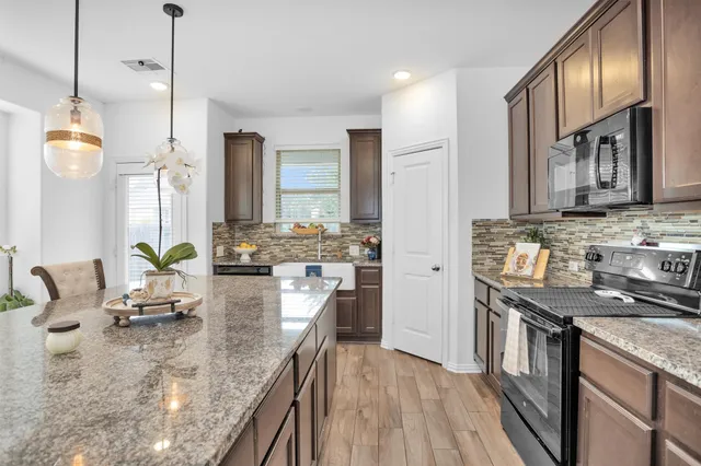 a living room with furniture and flowers