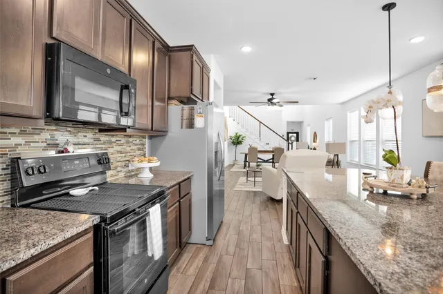 a bedroom with a bed a flat screen tv and a window