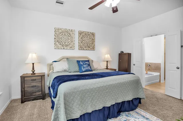 a living room with furniture a clock and a flat screen tv