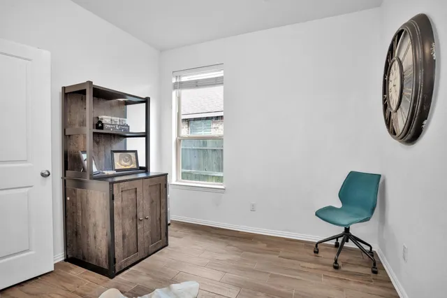 a living room with furniture and a mirror