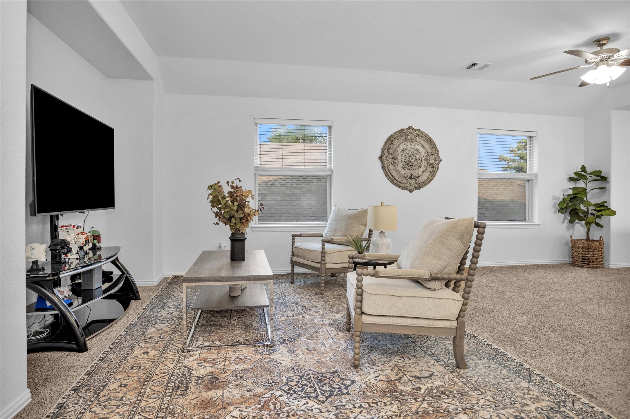 118 Emory Birch Montgomery, TX 77316 - Photo 22 of 35 a living room with furniture a clock and a flat screen tv