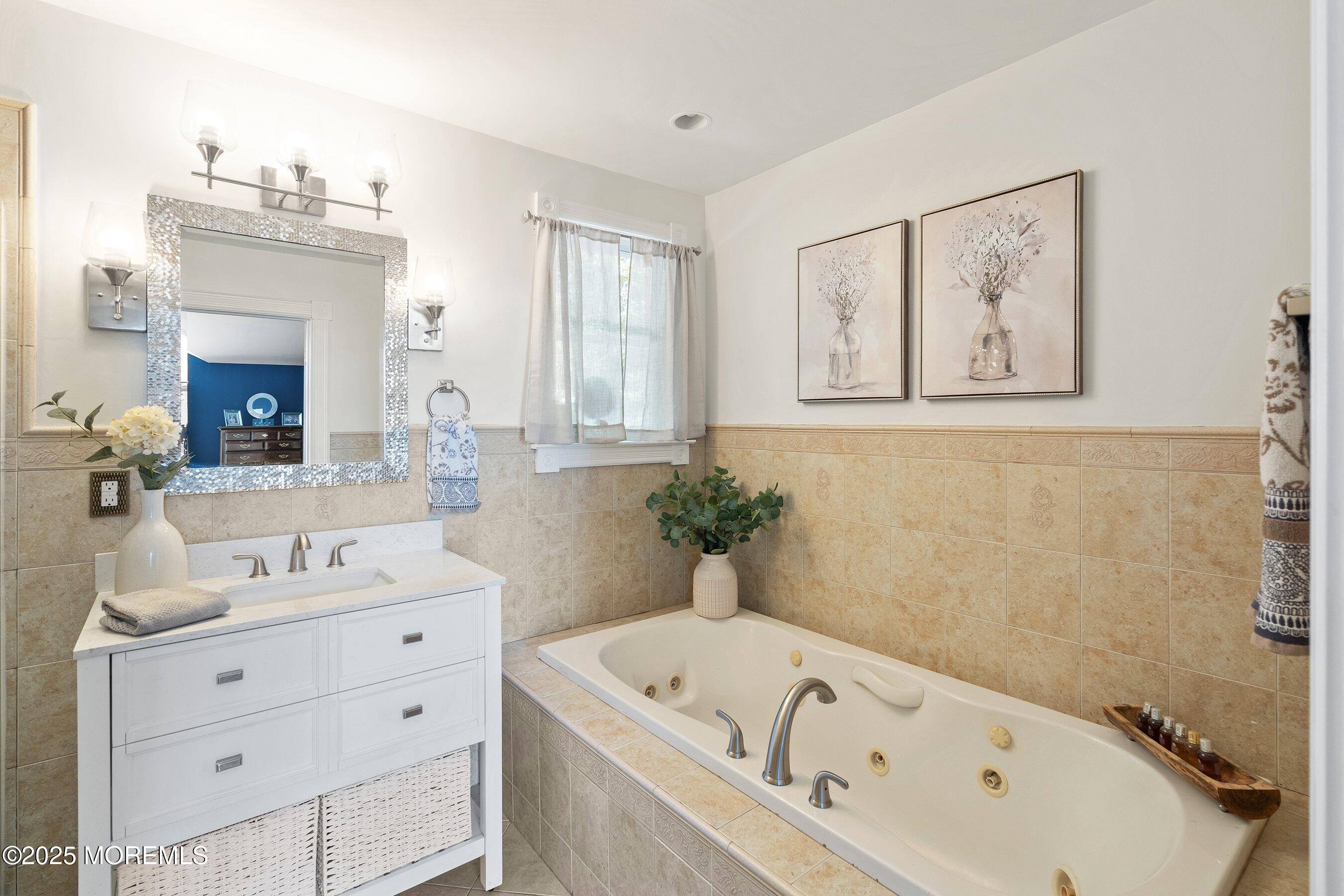 20 Appletree Road Howell, NJ 07731 - Photo 21 of 35 a bathroom with a tub a sink and mirror