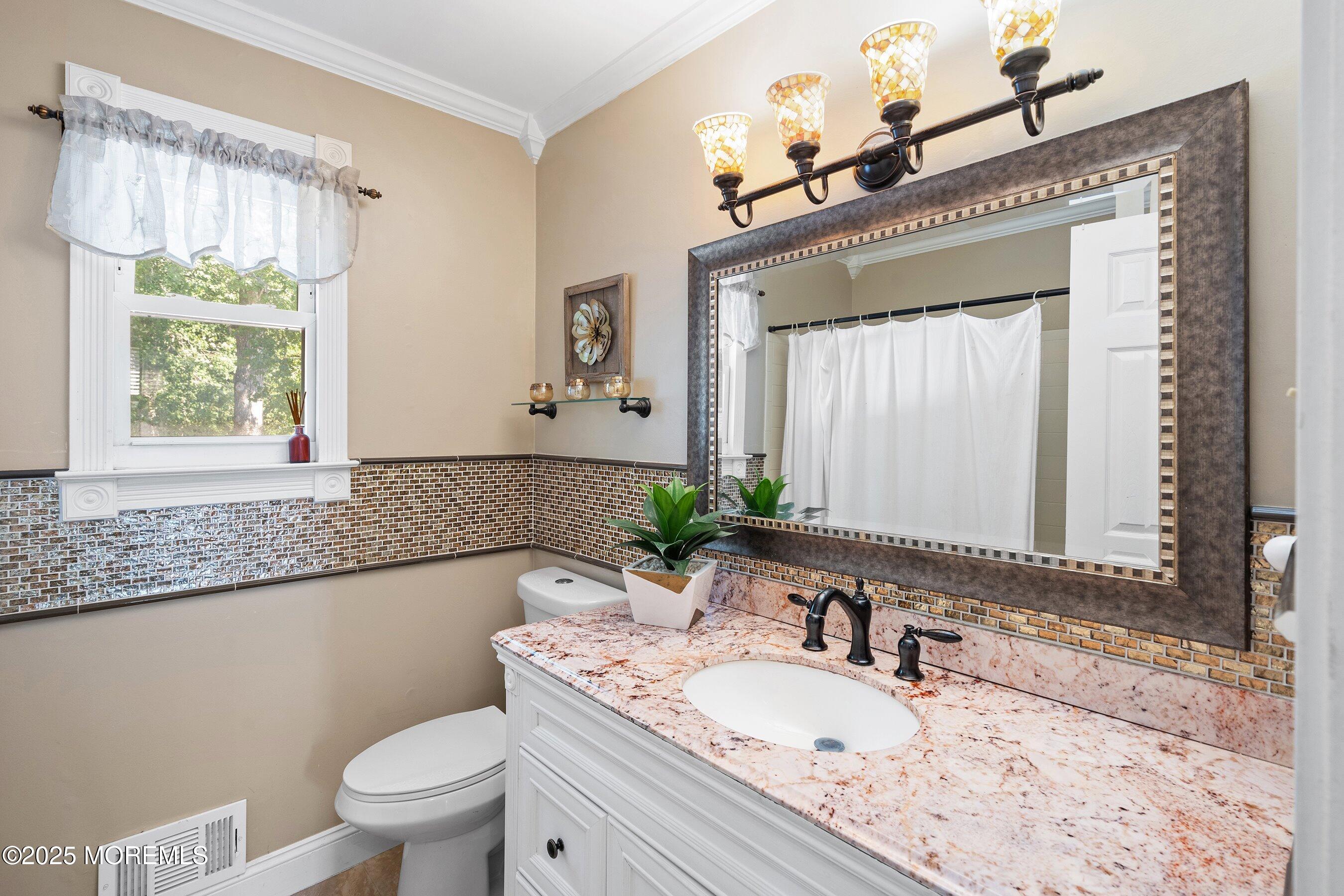 20 Appletree Road Howell, NJ 07731 - Photo 30 of 35 a bathroom with a granite countertop toilet a sink and a mirror