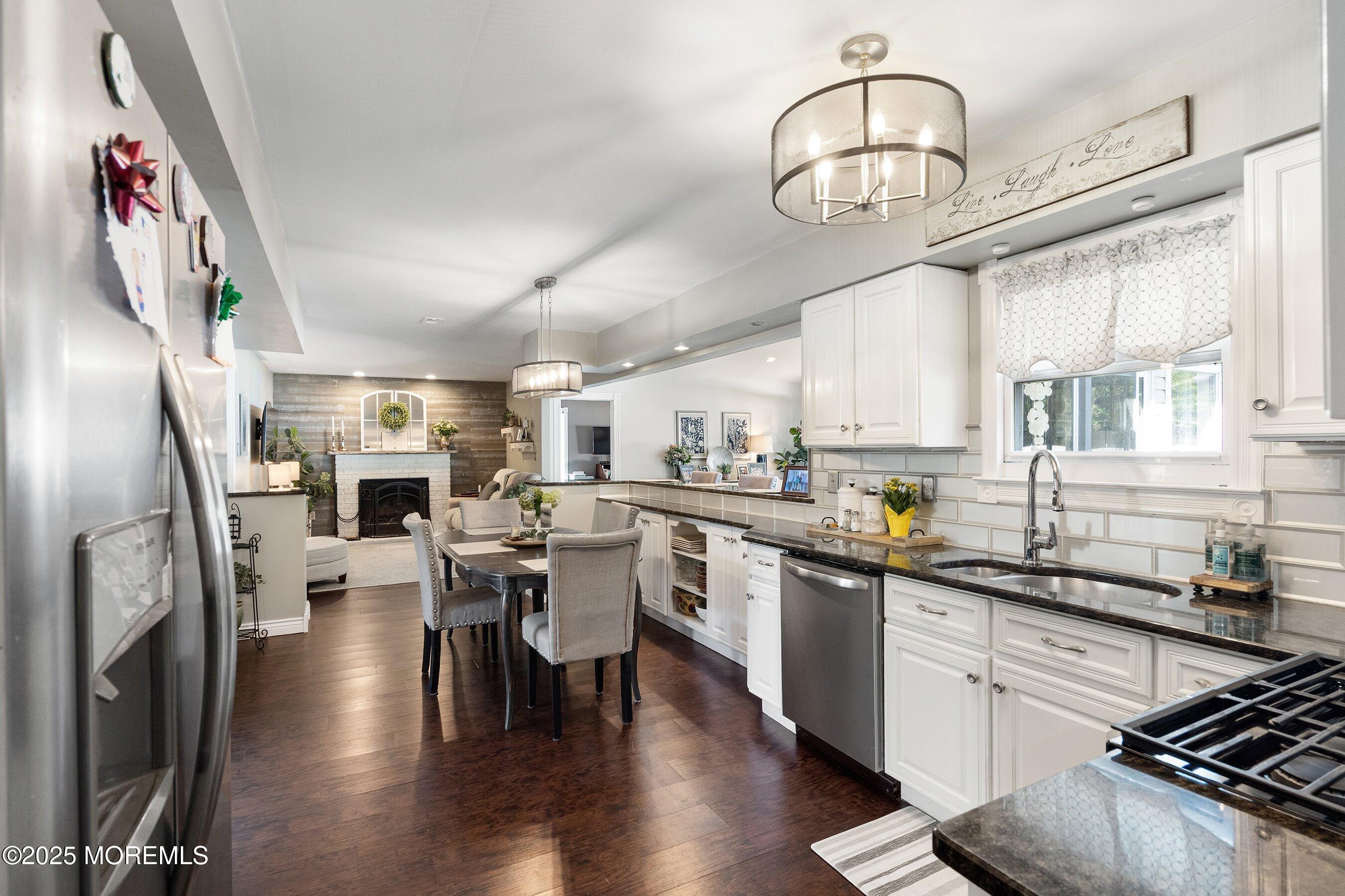 20 Appletree Road Howell, NJ 07731 - Photo 4 of 35 a kitchen with stainless steel appliances a kitchen island hardwood floor sink stove dining table and chairs