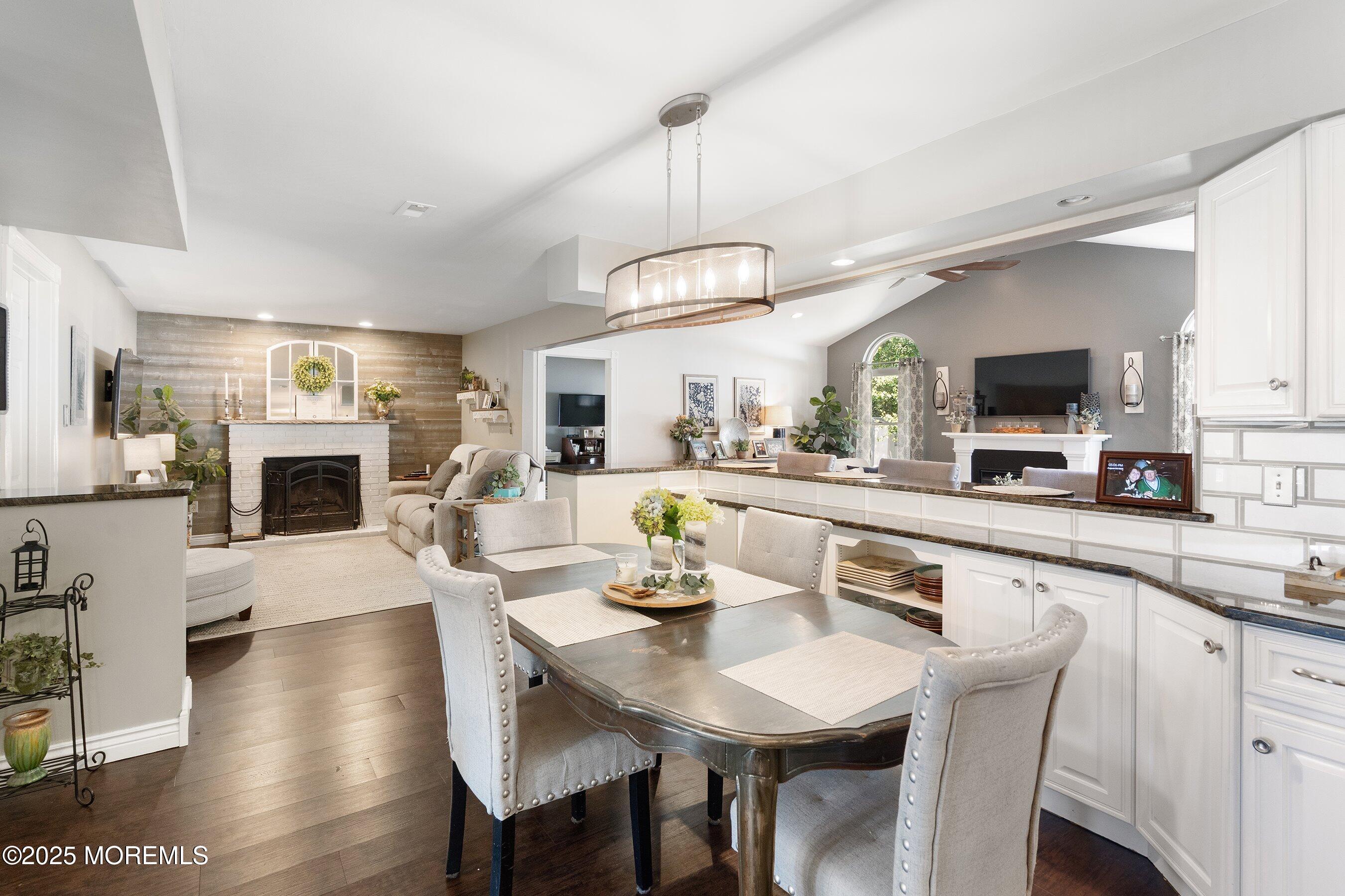 20 Appletree Road Howell, NJ 07731 - Photo 7 of 35 a kitchen with stainless steel appliances granite countertop a stove top oven a sink dishwasher a dining table and chairs with wooden floor