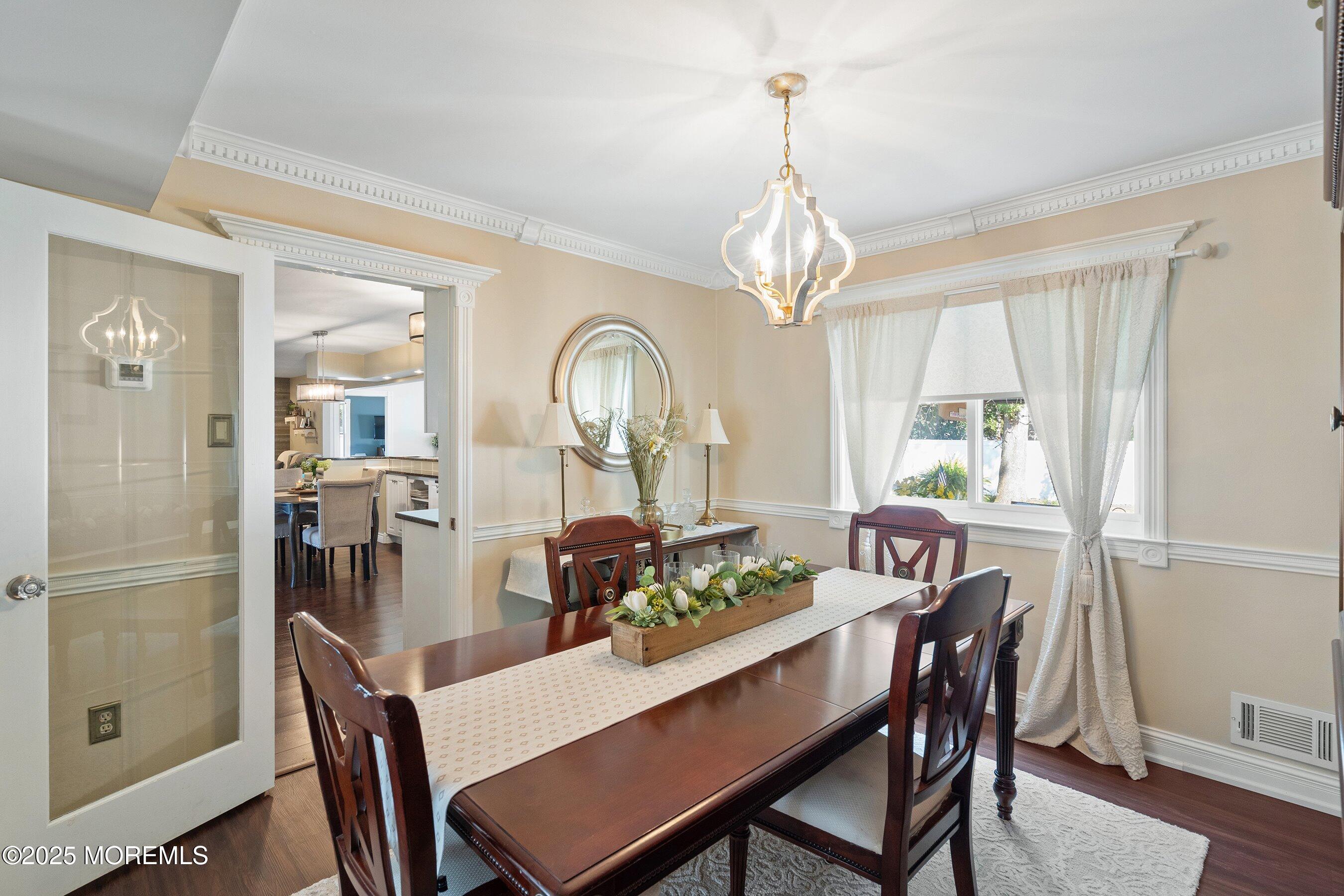 20 Appletree Road Howell, NJ 07731 - Photo 9 of 35 a view of a dining room with furniture a chandelier and wooden floor