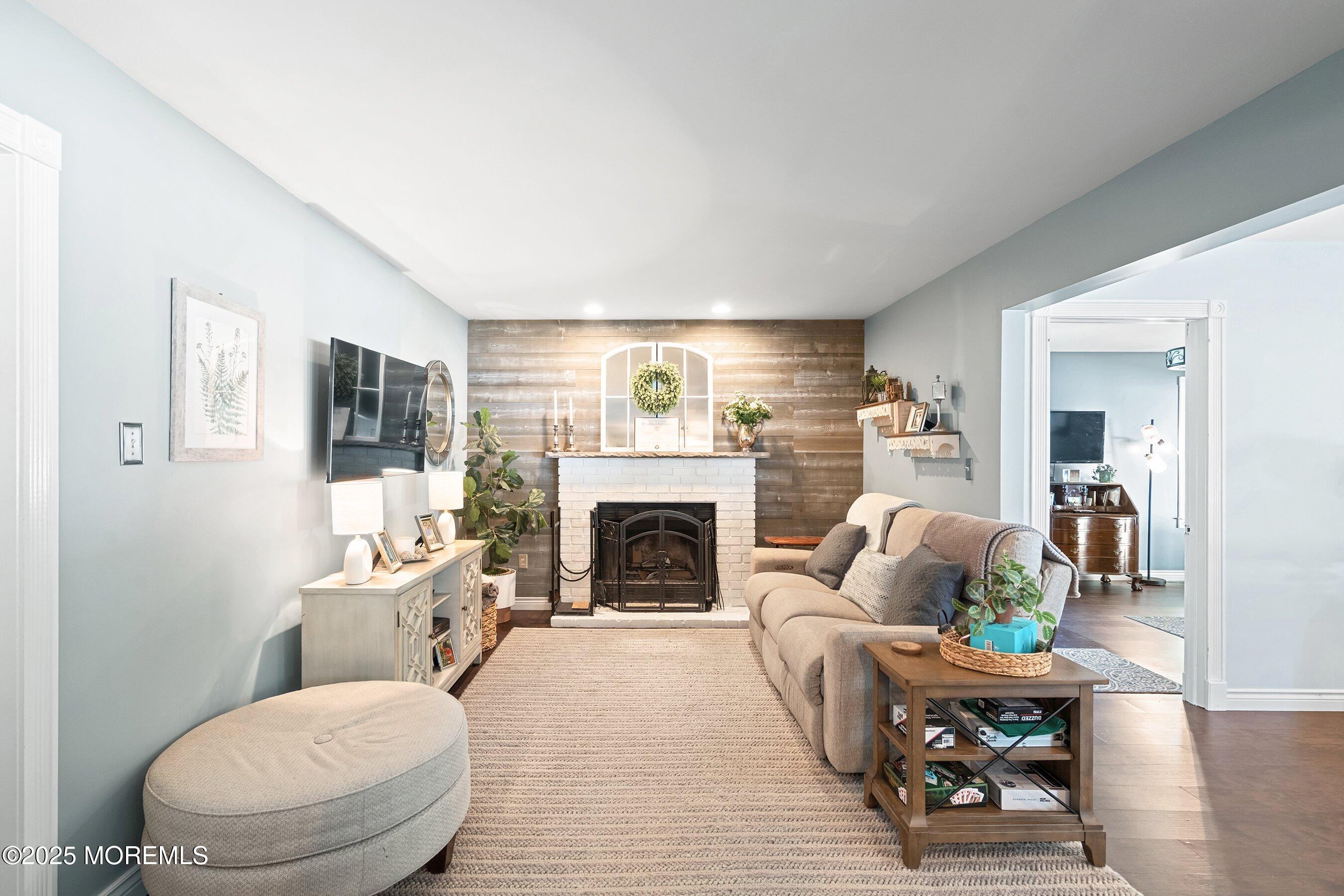 20 Appletree Road Howell, NJ 07731 - Photo 10 of 35 a living room with furniture a fireplace and a flat screen tv