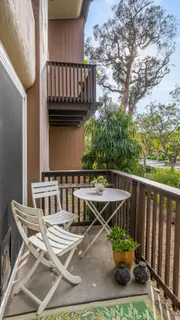a view of balcony with furniture