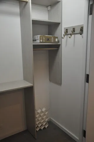 a room with water heater and cabinets