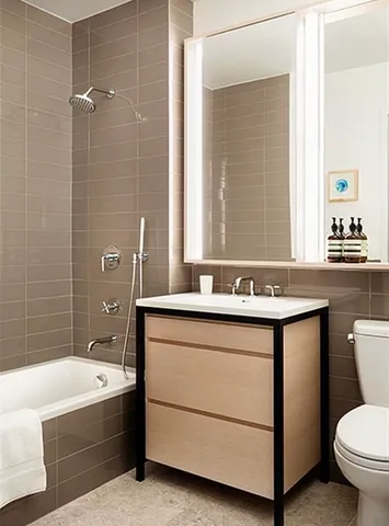 a bathroom with a sink double vanity mirror and a bathtub