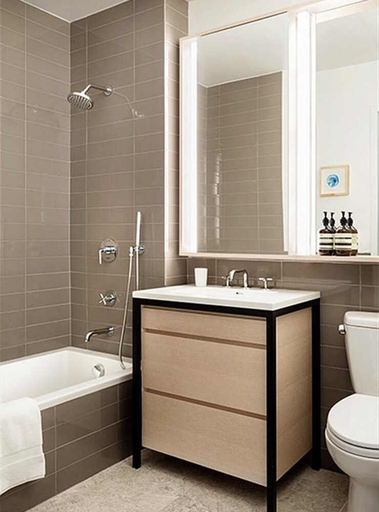 385 1st Avenue, Unit 12D Manhattan, NY 10010 - Photo 6 of 19 a bathroom with a sink double vanity mirror and a bathtub