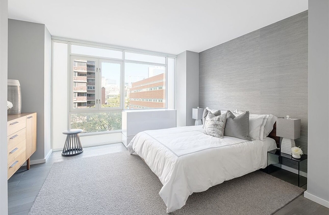 385 1st Avenue, Unit 12D Manhattan, NY 10010 - Photo 7 of 19 a bedroom with a bed and a large window