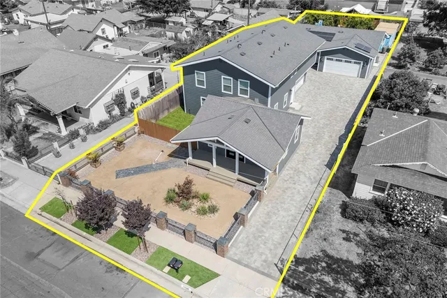 an aerial view of a house with a yard
