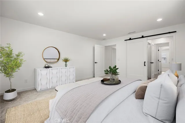 a bedroom with bed and a potted plant