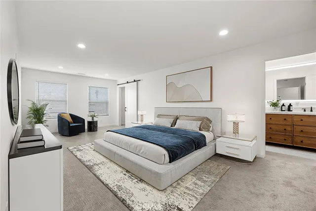 a spacious bedroom with a large bed and a couch