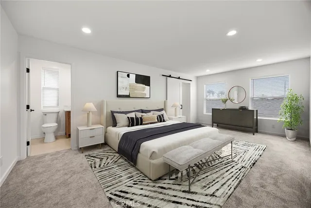 a spacious bedroom with a bed and a couch