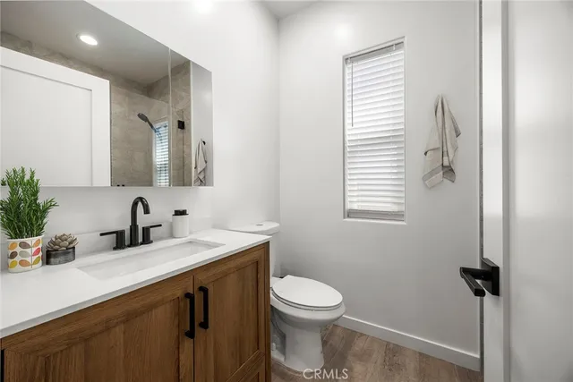 a bathroom with a sink a toilet and a mirror