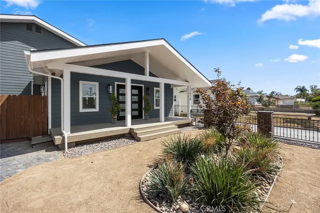 a view of a house with a small yard and plants