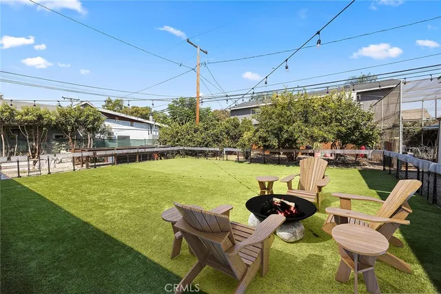 a swimming pool with outdoor seating and yard