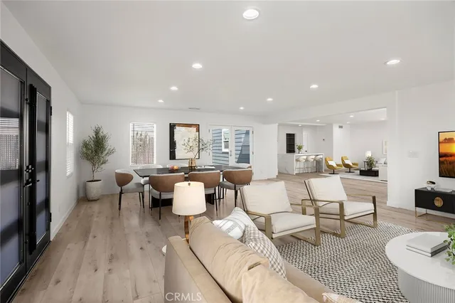 a living room with lots of furniture and view of kitchen