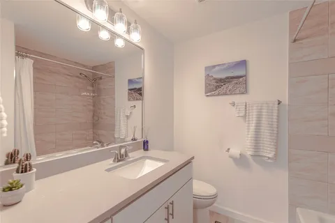 a en suite bathroom with a double vanity sink a mirror and a shower