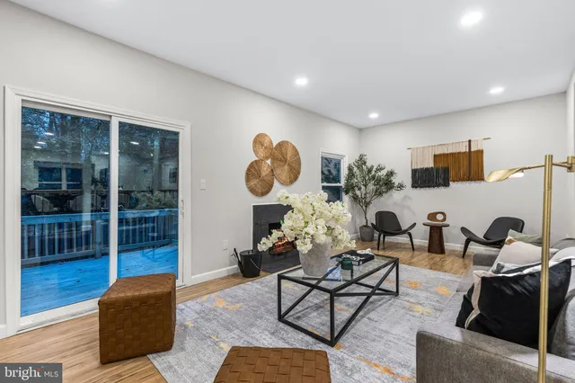 a bedroom with a large bed and wooden floor