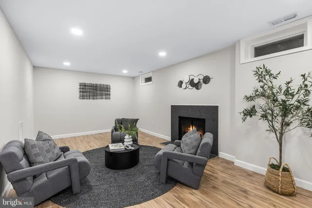 a living room with furniture and a fireplace