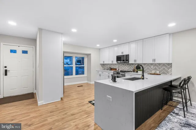 a kitchen with a stove a sink and a microwave