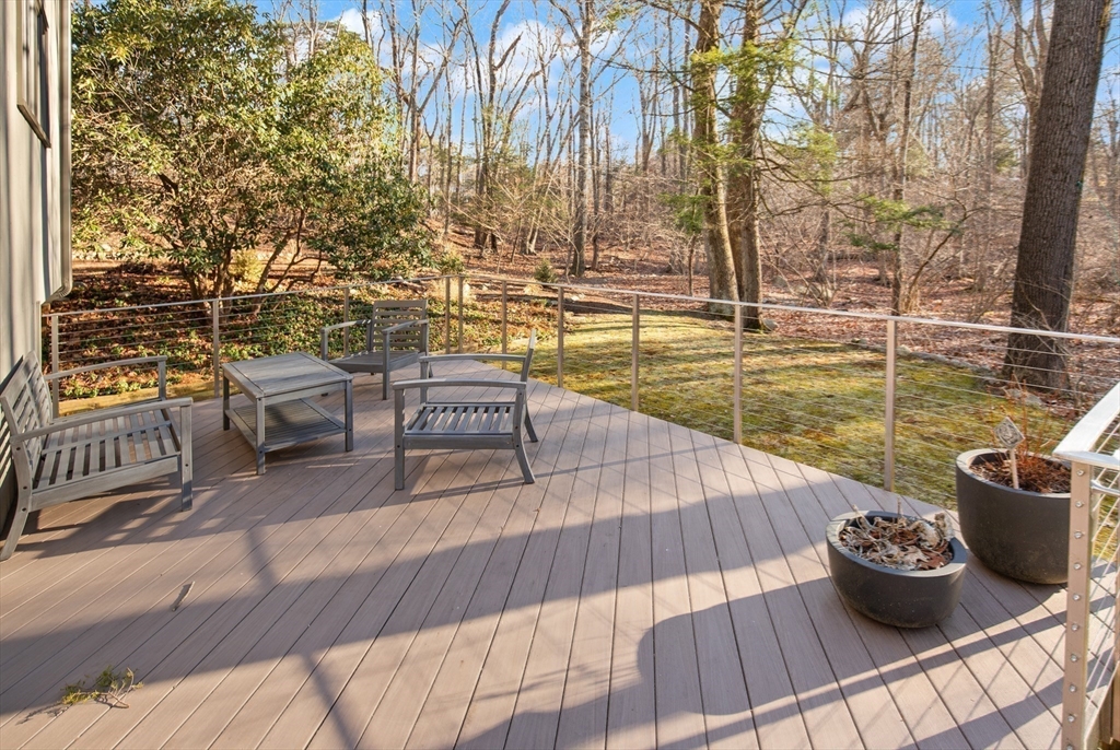 175 Mountain Street Sharon, MA 02067 - Photo 5 of 28 a view of a balcony with dining table and chairs with wooden floor