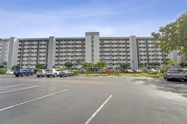 a view of parking with a cars parked in front of it