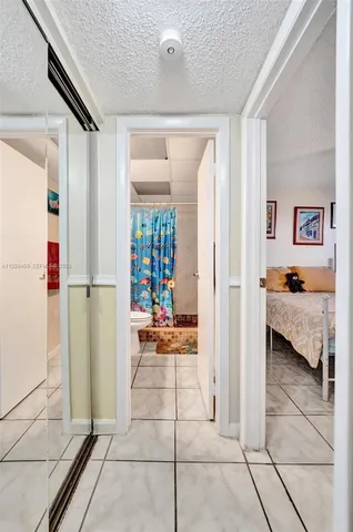 a living room with stainless steel appliances furniture a fireplace and a flat screen tv