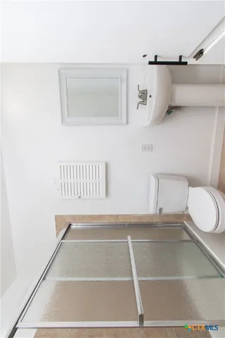 a bathroom with a toilet a sink and mirror