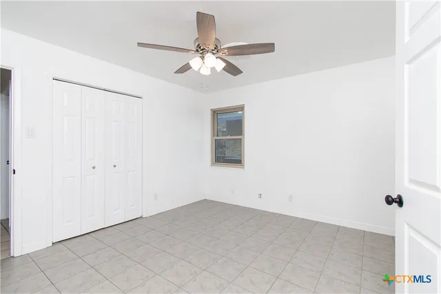 a view of a room with a ceiling fan