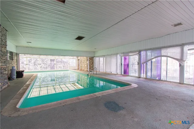 a room with window and pool table