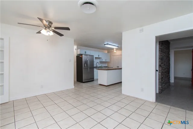 a open kitchen with white cabinets and stainless steel appliances