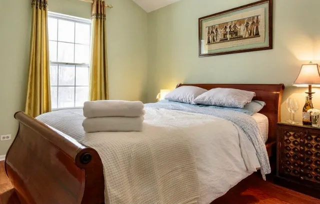 a bedroom with a bed and a window