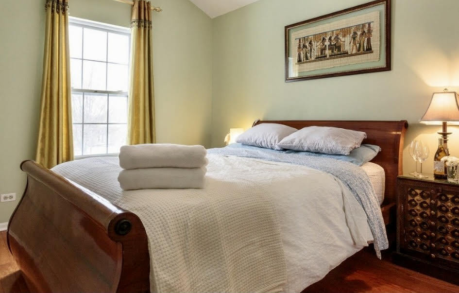 671 Wintergreen Circle Naperville, IL 60540 - Photo 11 of 17 a bedroom with a bed and a window