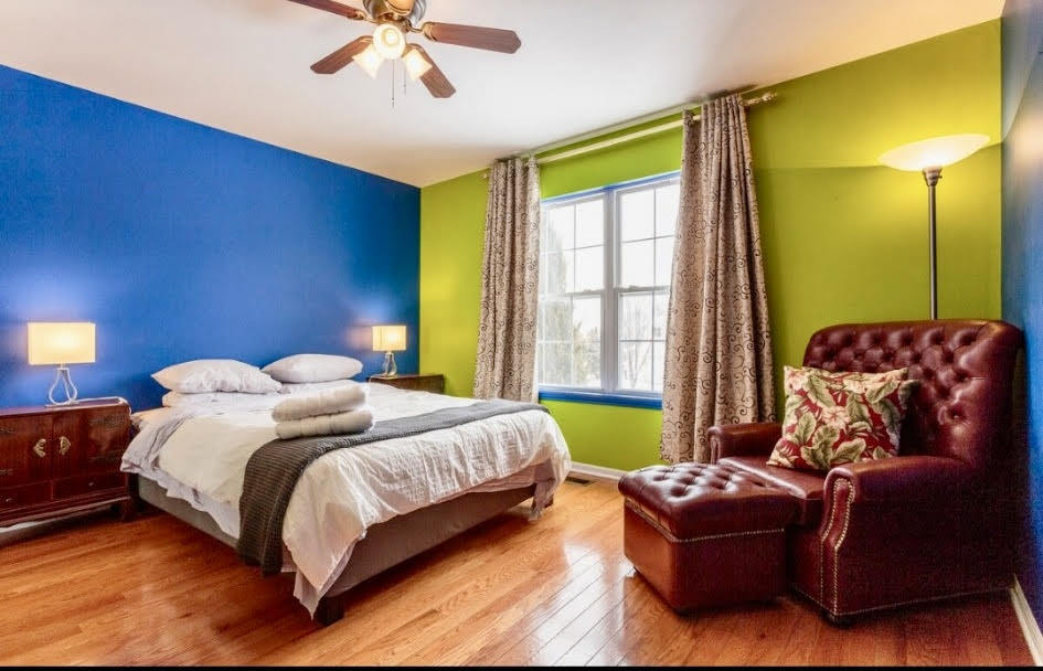 671 Wintergreen Circle Naperville, IL 60540 - Photo 12 of 17 a bedroom with a bed and a chandelier