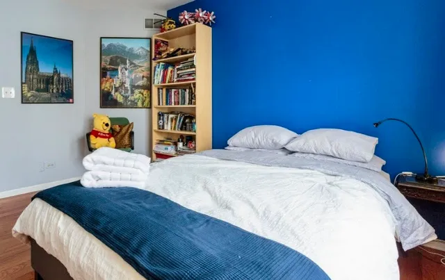 a bedroom with a bed and dresser