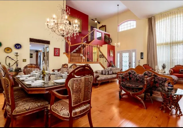 a living room with furniture a window and a chandelier